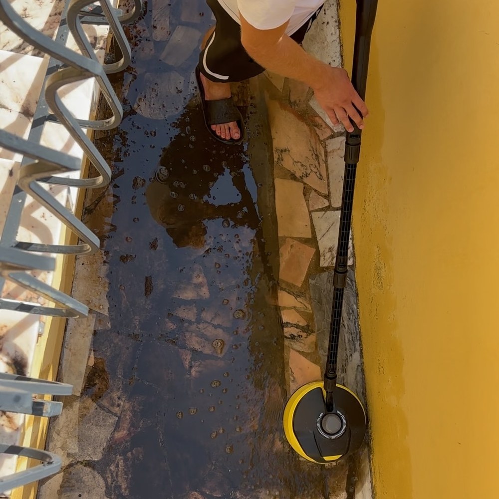 Working along the base of a villa wall in Vale do Lobo before pressure washing
