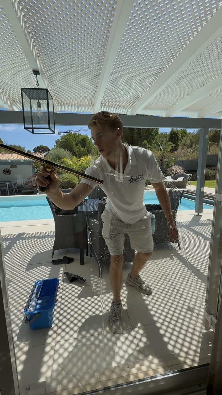 Carrying poles across the pool terrace at a villa in Quinta do Lago