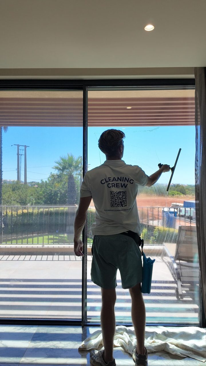 Cleaning the inside face of the glass at a villa in Vale Formoso, Almancil