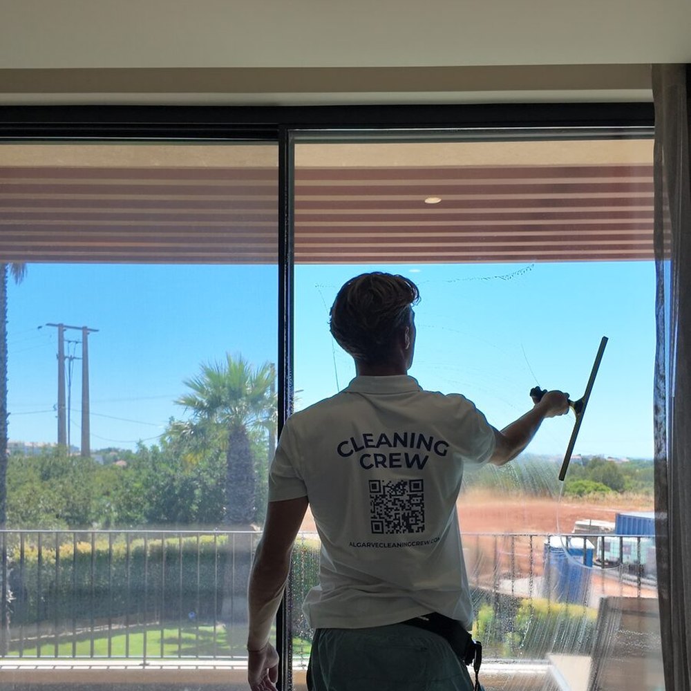 Cleaning the inside face of the glass at a villa in the Algarve