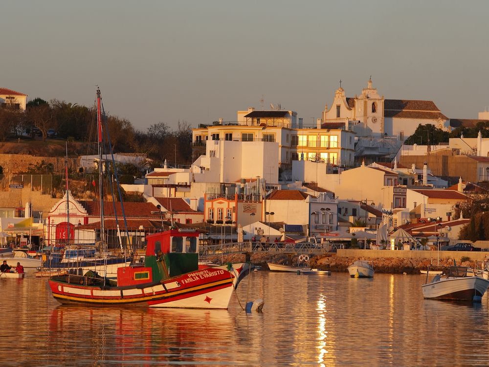 Fishing boats in front of Alvor village at sunset, Algarve
