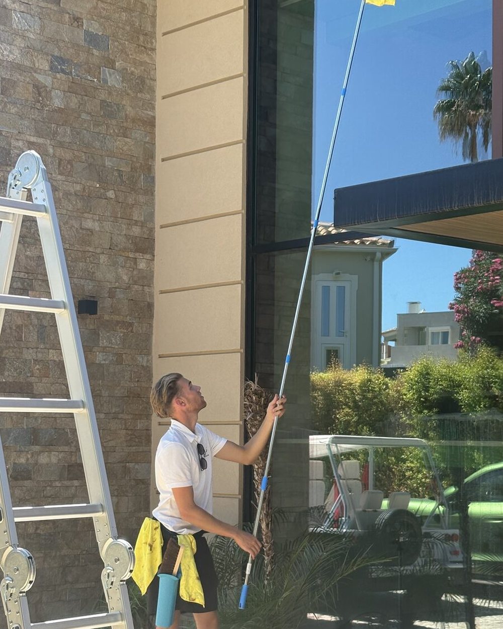 Algarve Cleaning Crew ladder and pole window cleaning on a white rendered villa