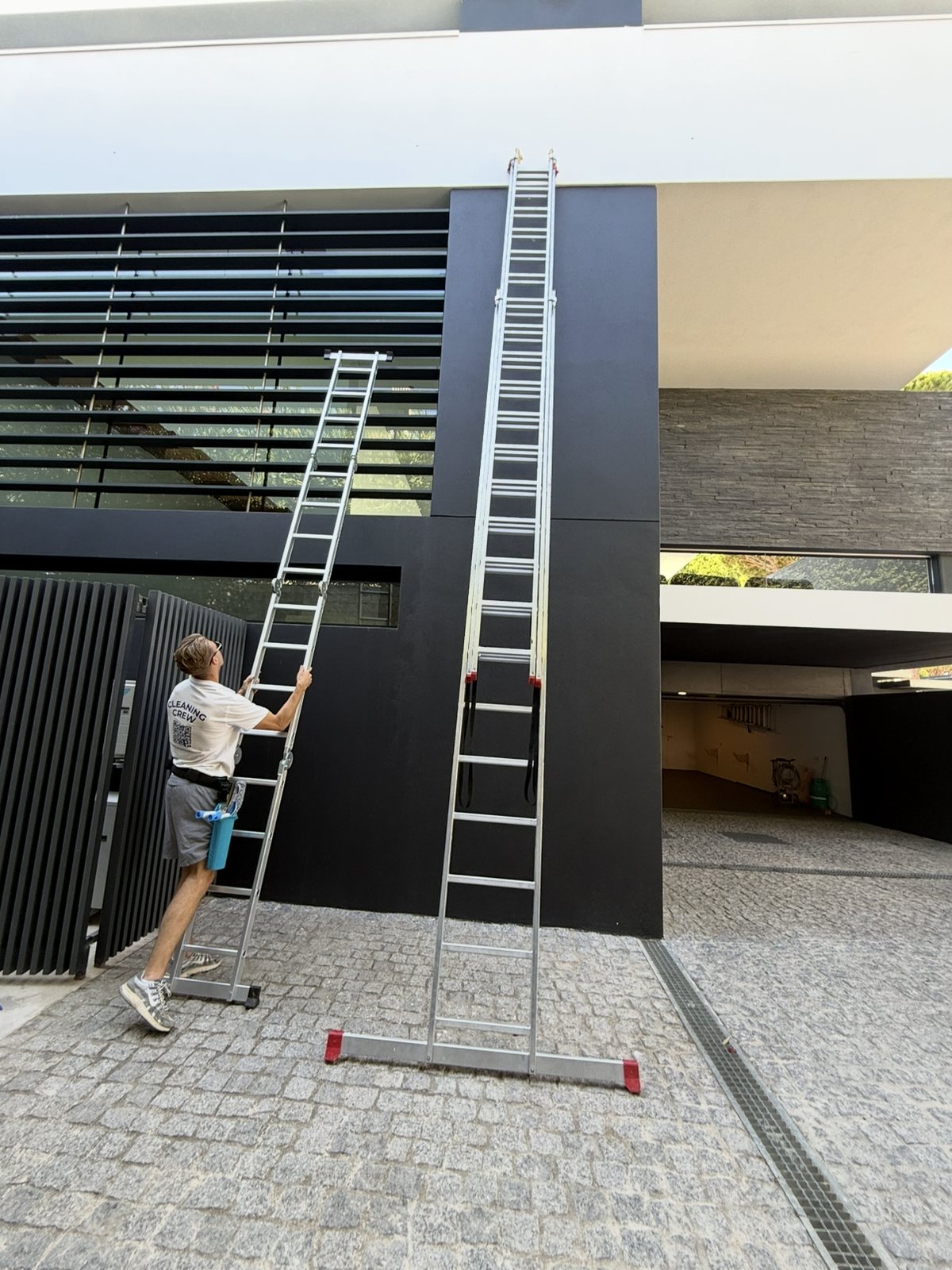 Two very tall ladders set against a modern villa in Vale do Lobo