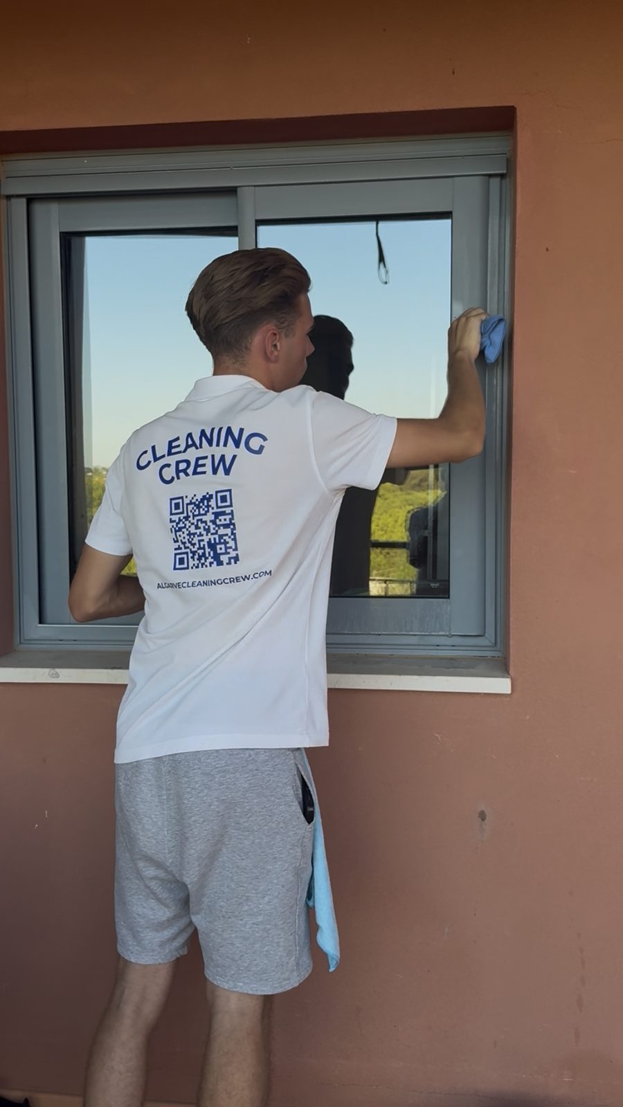 Applicator and solution going onto apartment window glass in Vilamoura