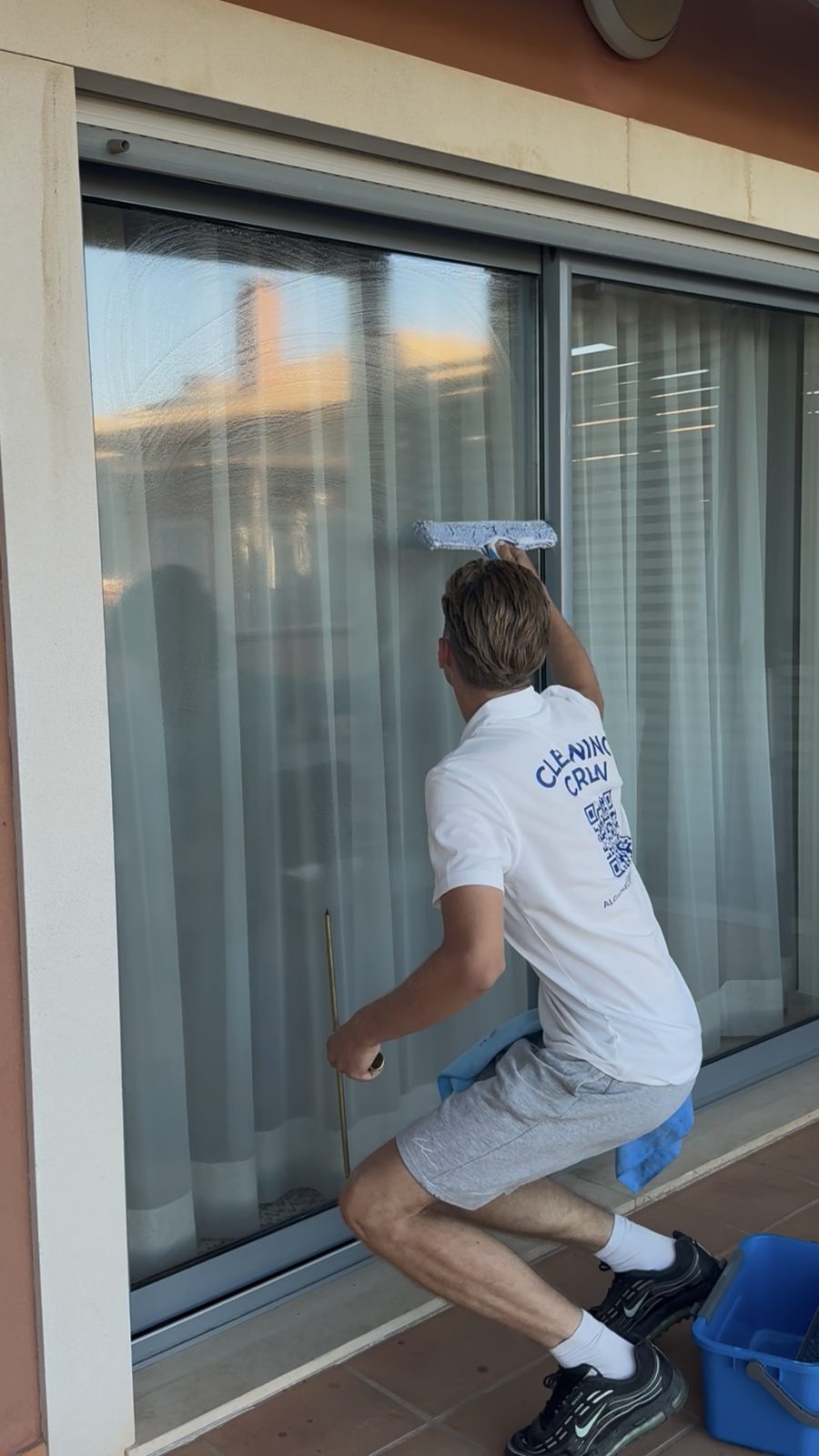 Algarve Cleaning Crew cleaning the exterior of a sliding patio door at an apartment in Vilamoura