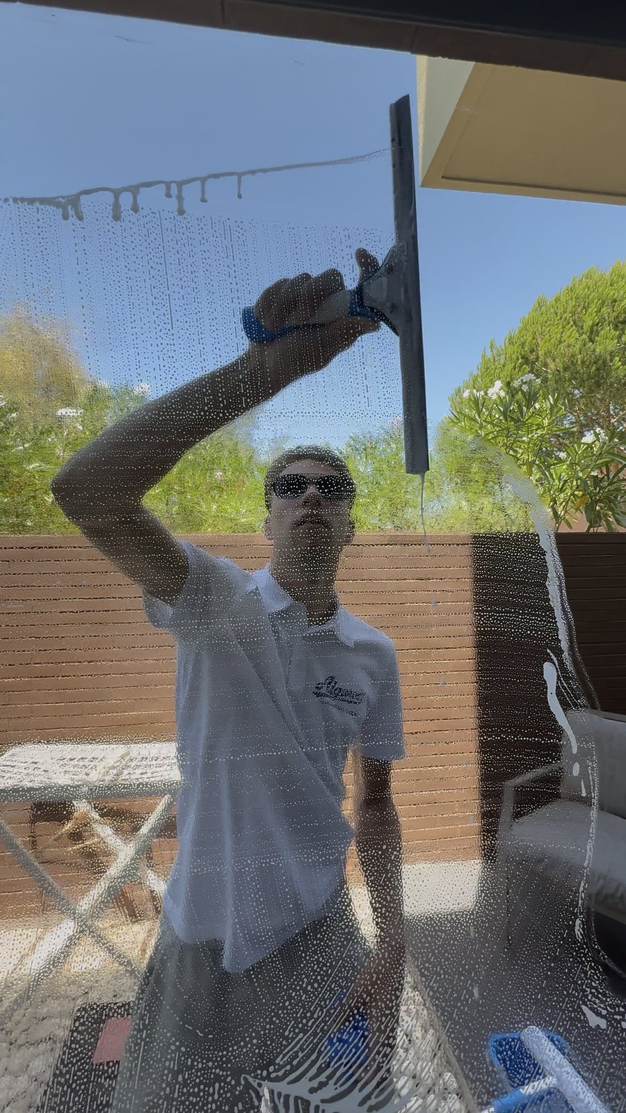 Squeegee window cleaning on apartment glass in Vilamoura, Algarve