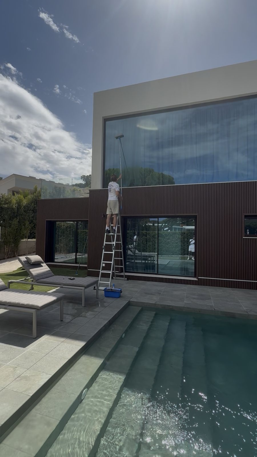 The glass elevation and pool of a modern villa in Vale do Lobo