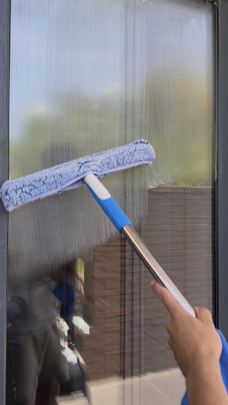 Close-up of a window cleaning applicator on apartment glass in Vilamoura